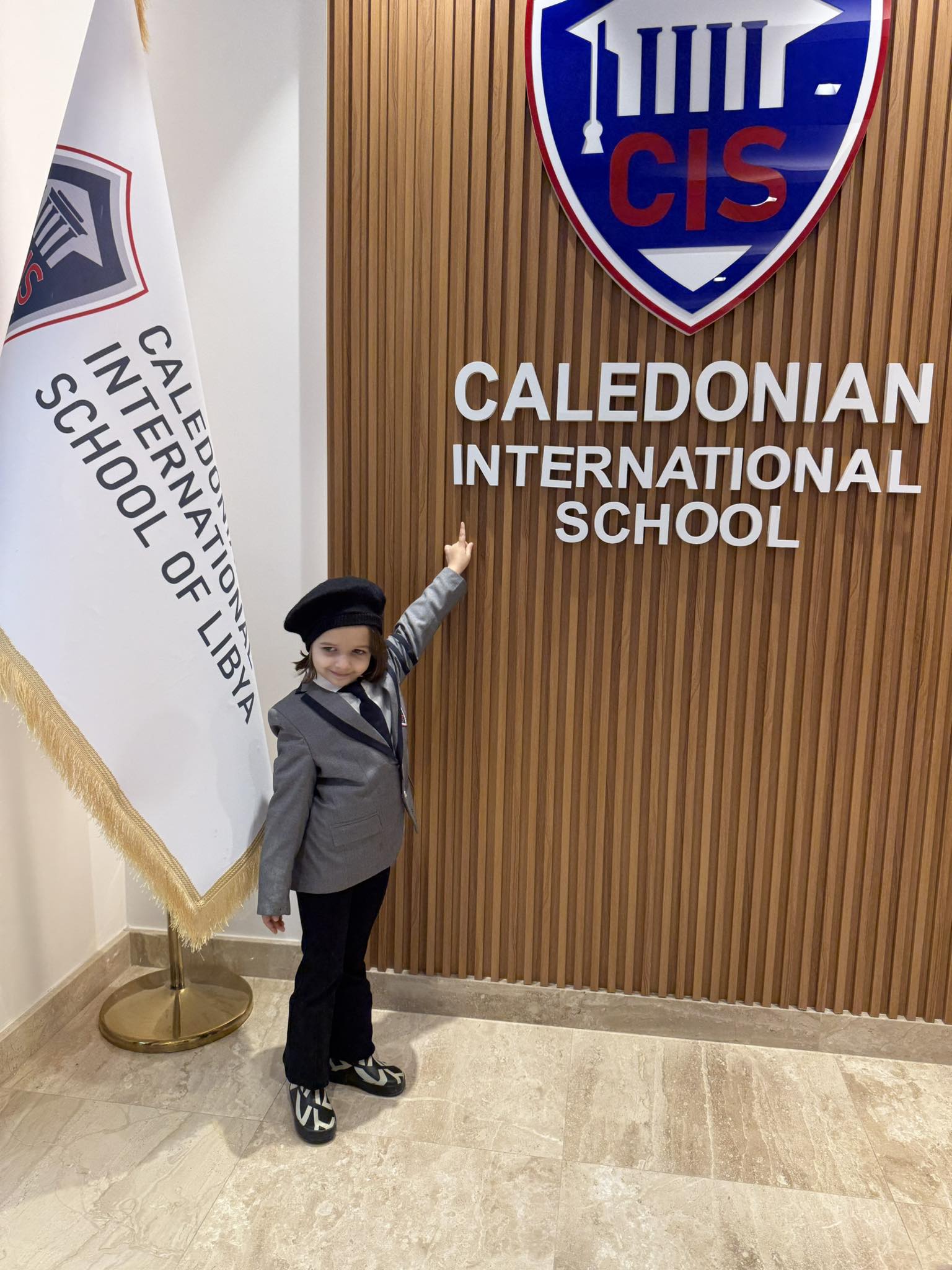 Caledonian International School student at the reception wall
